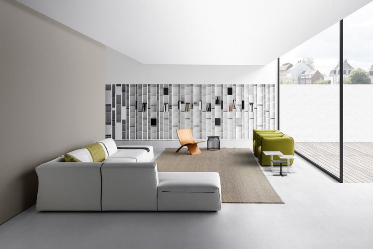 Three K Tabes, two in white ceramics tabletops and white steel frames and one in grey ceramics tabletops and grey steel frames on a livingroom background.