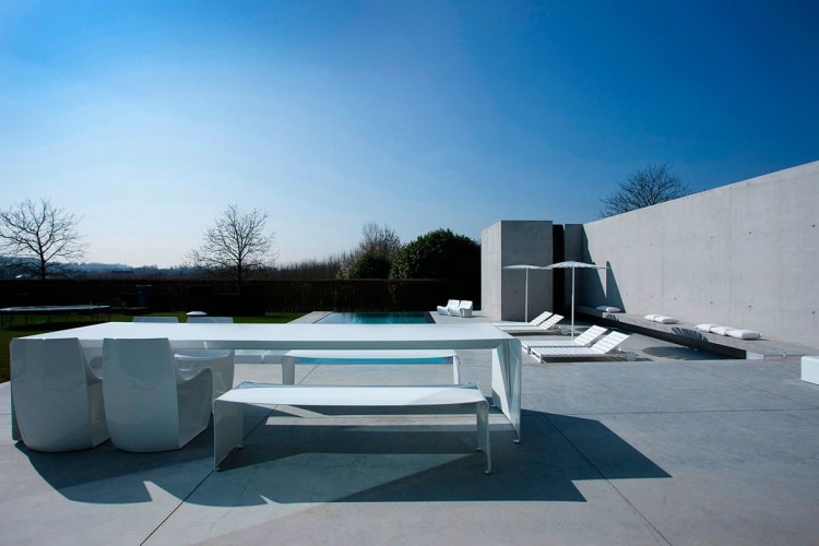 Two La Grande Tables made with a curved aluminium sheet. Finish in gloss white lacquered on a outdoor background.