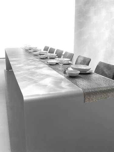 One La Grande Table made with a curved aluminium sheet. Finish in gloss white lacquered on a dining room background.