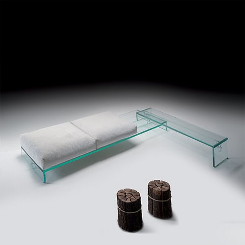 Simplicity Bench showcasing a sleek glass structure paired with cylindrical upholstered stools for a contemporary and minimalist aesthetic