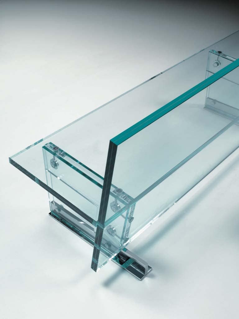 A transparent glass Simplicity Bench with a modern design, featuring a sturdy glass seat and backrest supported by sleek metal brackets for stability