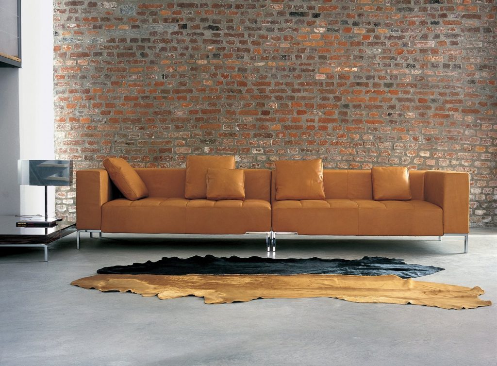 Alfa sofa with a rectangular brown seat and backrest, featuring silver legs in a living room.