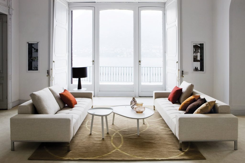 Two Alfa sofas with a rectangular grey seat and backrest, featuring silver legs in a living room.