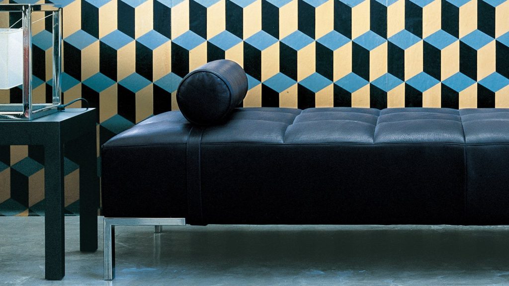 Alfa sofa with a rectangular black seat, featuring silver legs in a living room.