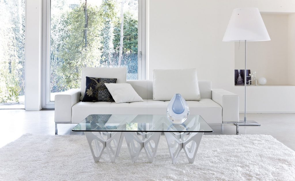 Alfa sofa with a rectangular white seat and backrest, featuring silver legs in a living room.
