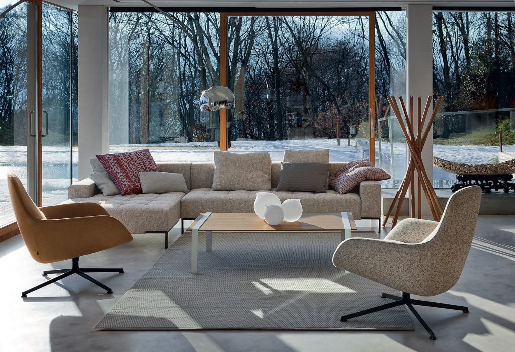 L shaped Alfa sofa with a rectangular white seat and backrest, featuring silver legs in a living room.
