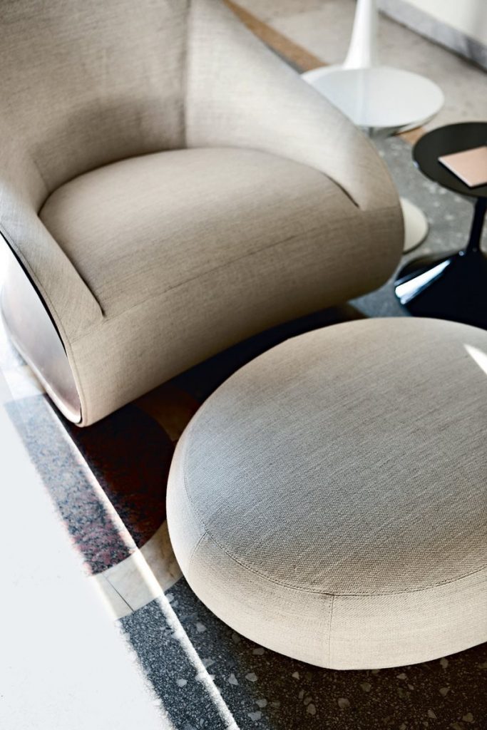 Derby armchair upholstered seat and backrest in white in a living room.