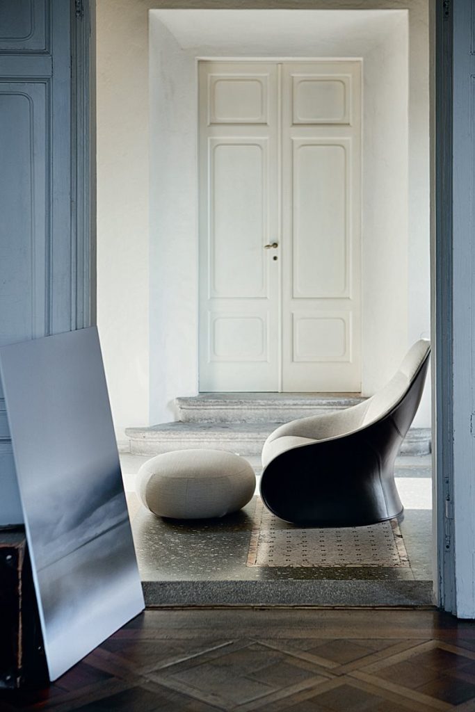 Derby armchair upholstered seat and backrest in white and brown in a living room.