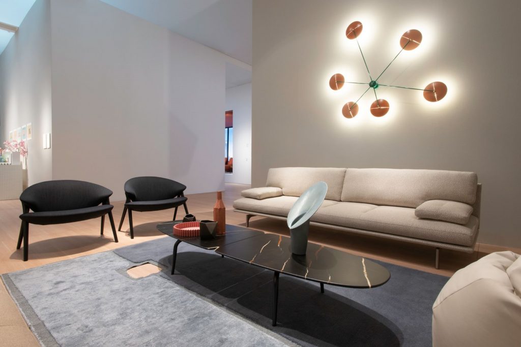 Graphium coffee table. Oval brown, white and black marble top and four black legs in a living room.