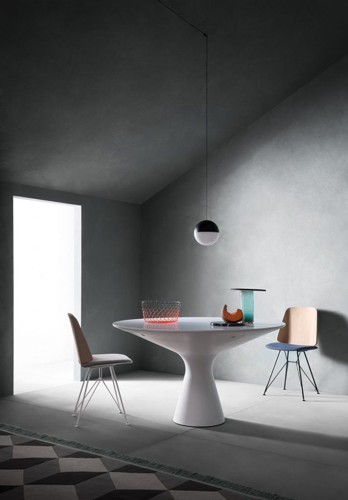 Two June chairs with a blue cushioned seat and natural wood backrest on a gray background.
