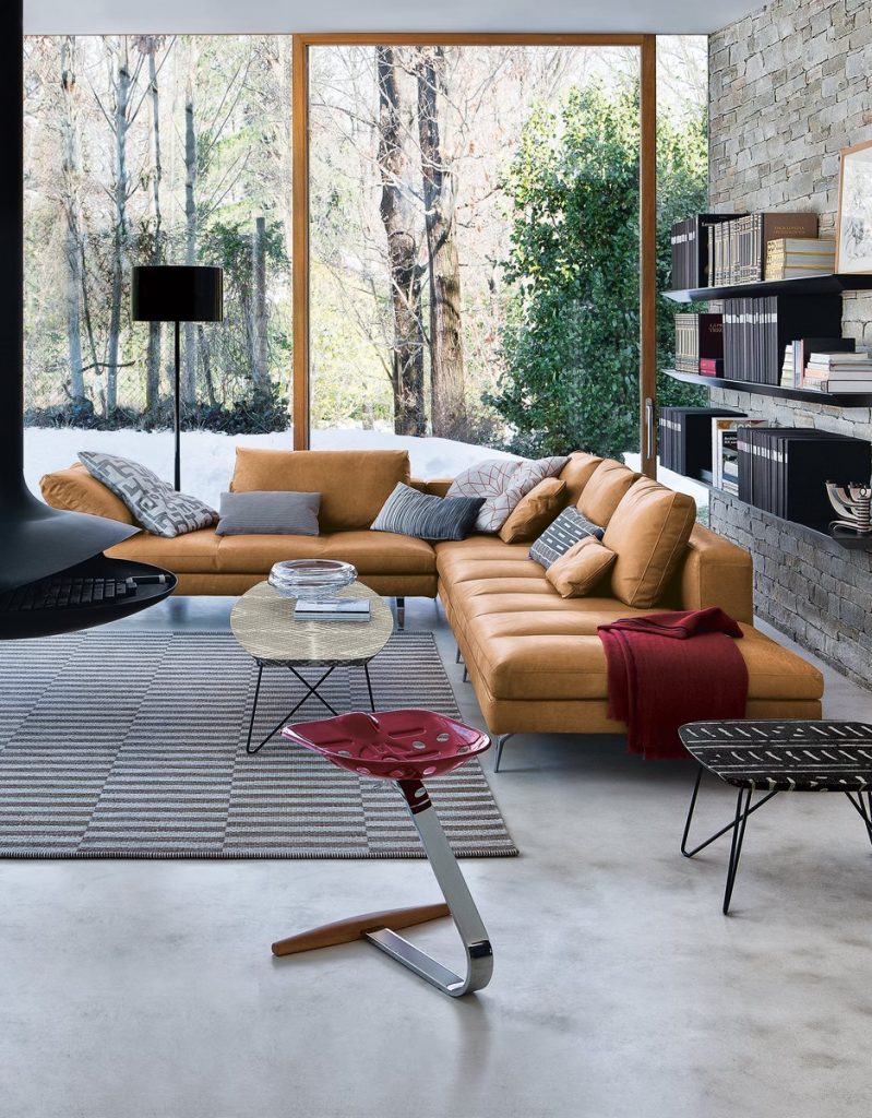 Mezzadro red stool with a unique design, featuring a red seat on a chrome base in a living room.