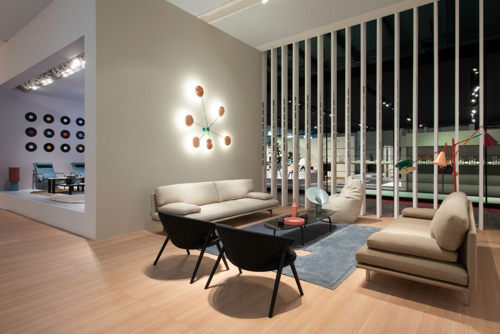 Two beige Milano+ sofas with armrest and backrest and a black metal frame in a living room.