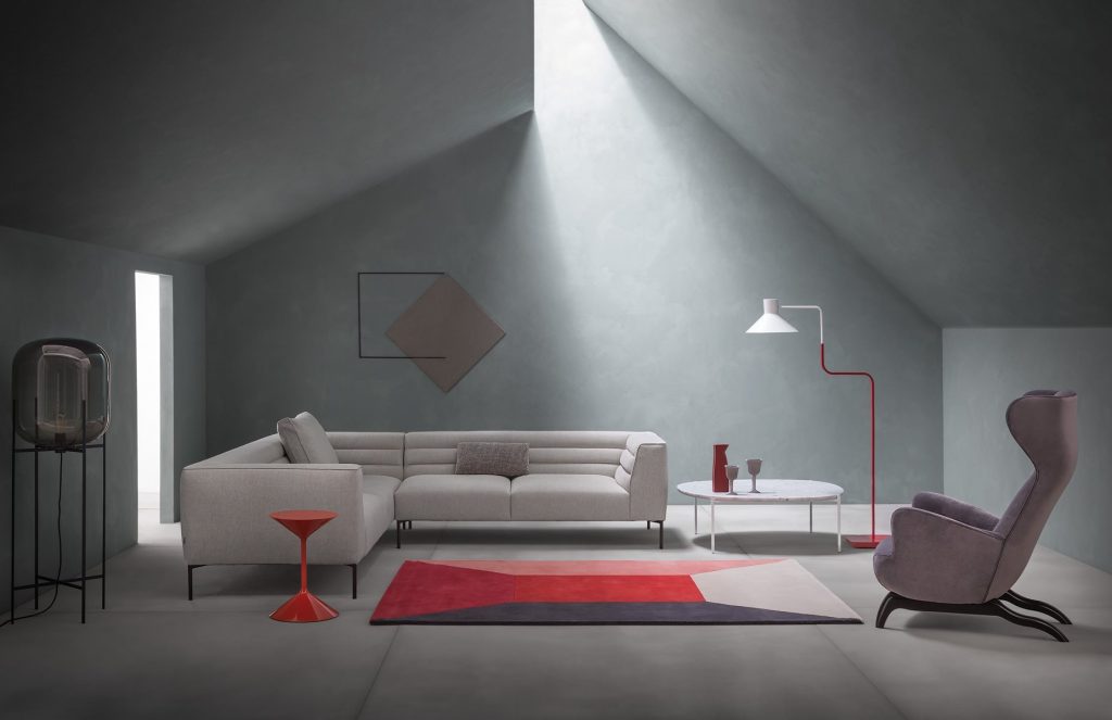 Niobe 671 672 coffee table with round top in gray and white marble, and black slender metal legs in a living room.