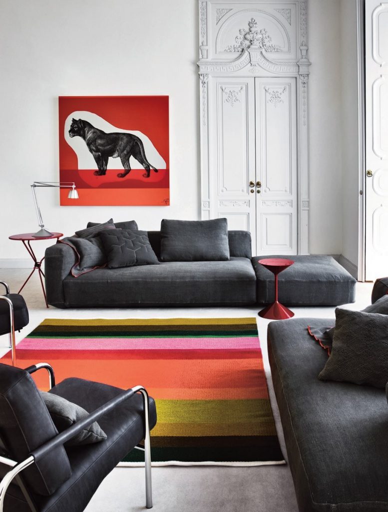 Tempo coffee table, round top and base in red in a living room.