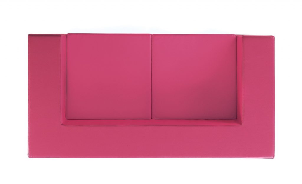 Throw-Away sofa featuring pink fabric upholstery and a boxy shape on a white background.