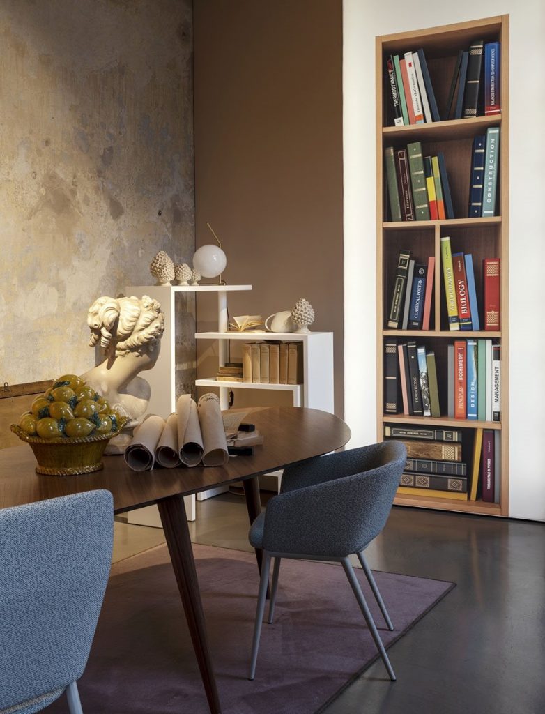 Two Tusa 2261/B chair with a curved backrest and seat upholstered in dark gray fabric in a dining room.