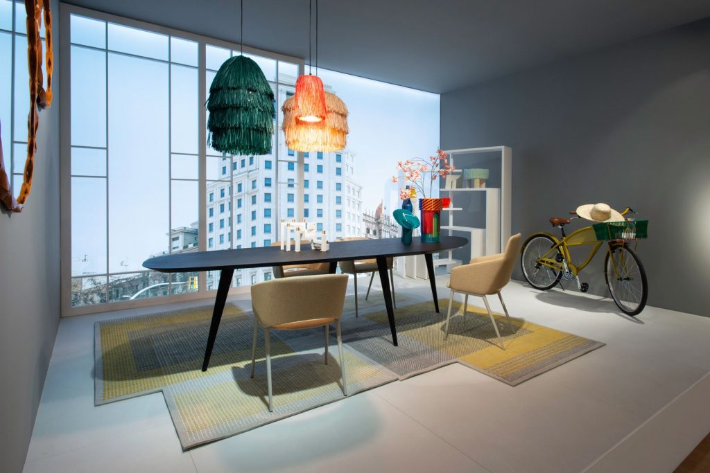 Four Tusa 2261/B chair with a curved backrest and seat upholstered in dark gray fabric in a dining room.