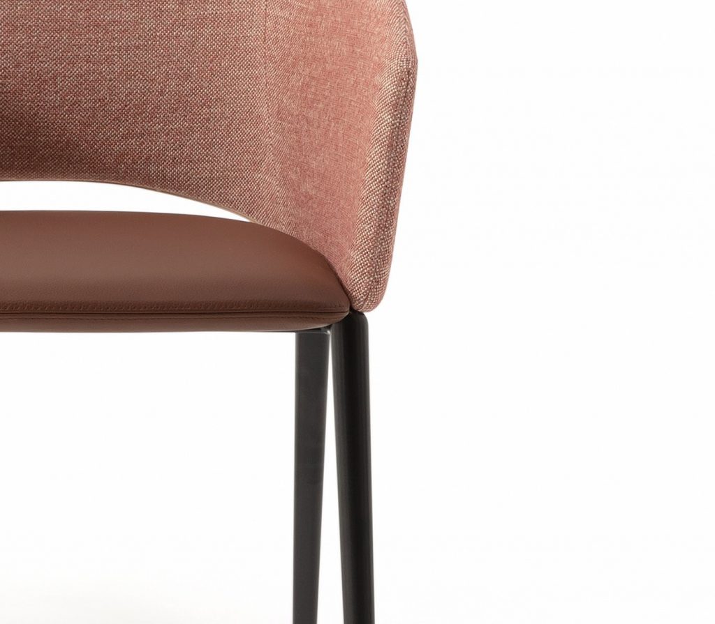 Closeup of Tusa 2261/B chairs with a curved backrest and seat upholstered in orange fabric on a white background.