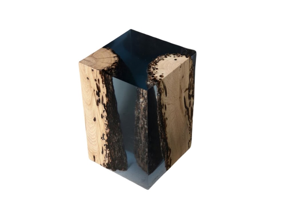 A sculptural stool that merges raw wood and clear resin in a twisted anchor-like form, creating both stability and visual depth.