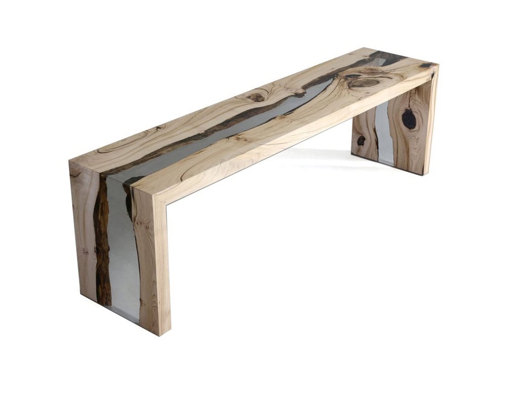 The Creek Bench combines natural wood with clear resin, creating a flowing river-like effect. Its minimalist form highlights organic textures, making it both functional and sculptural.