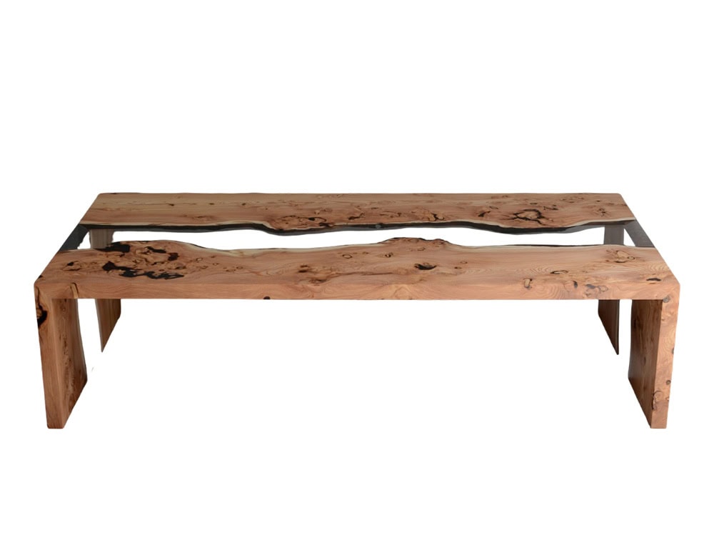 A refined coffee table crafted from natural wood and transparent resin. Its flowing river-like design highlights organic grain patterns, blending raw textures with modern geometry for a striking centerpiece.