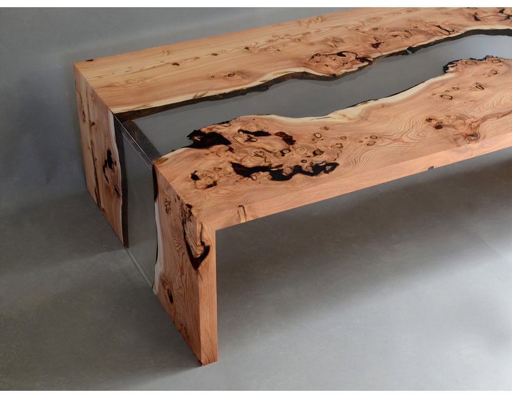 This coffee table pairs natural wood with transparent resin, creating a striking river-like design. Its minimalist form highlights the organic grain, adding warmth and modern elegance to any interior.