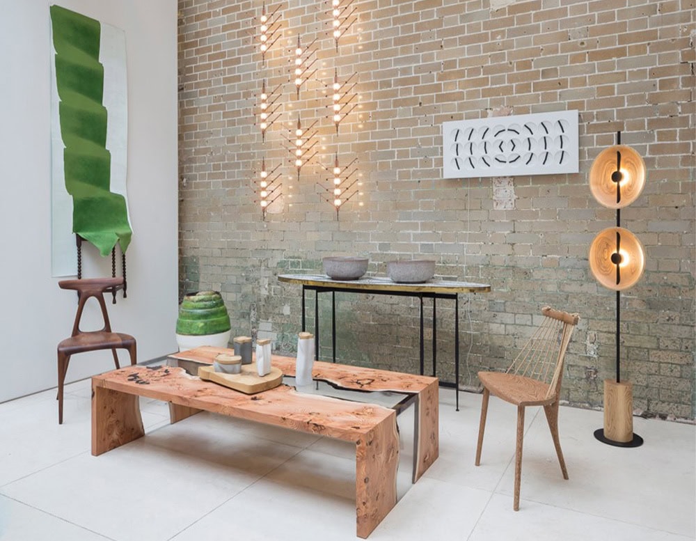 This coffee table combines live edge wood with clear resin, highlighting the natural flow of the grain. Its modern low form brings warmth and elegance to contemporary interiors.