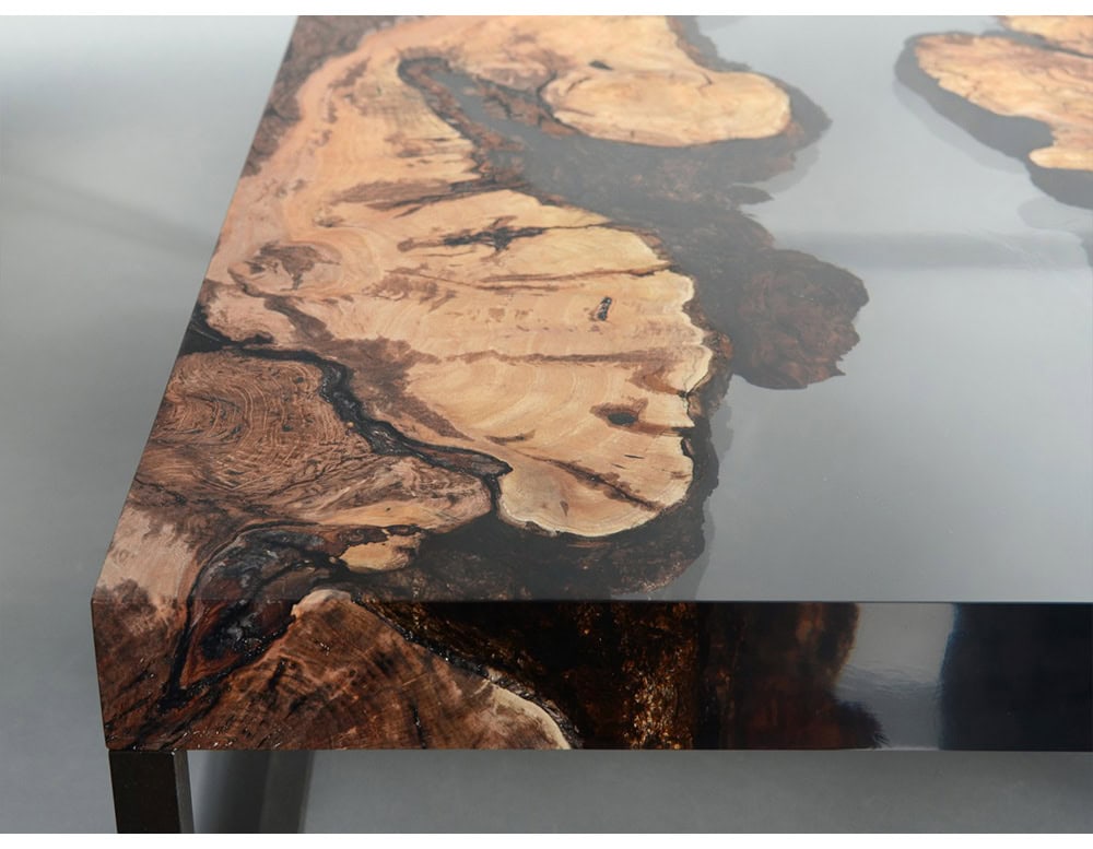This low table combines live-edge wood and glossy resin to create a bold design. The natural grain contrasts with polished surfaces, offering a unique balance of raw artistry and modern sophistication.