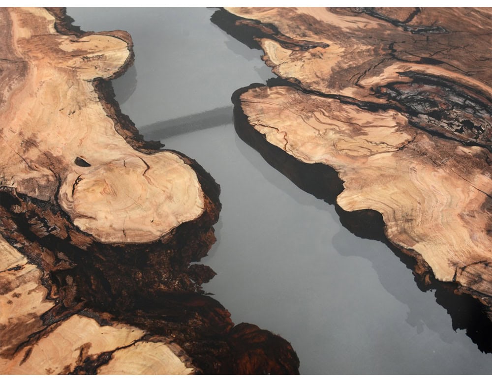 A striking low table combining natural wood grain with a sleek resin river detail. The design evokes flowing water through rugged landscapes, blending organic warmth with modern elegance for refined interiors.