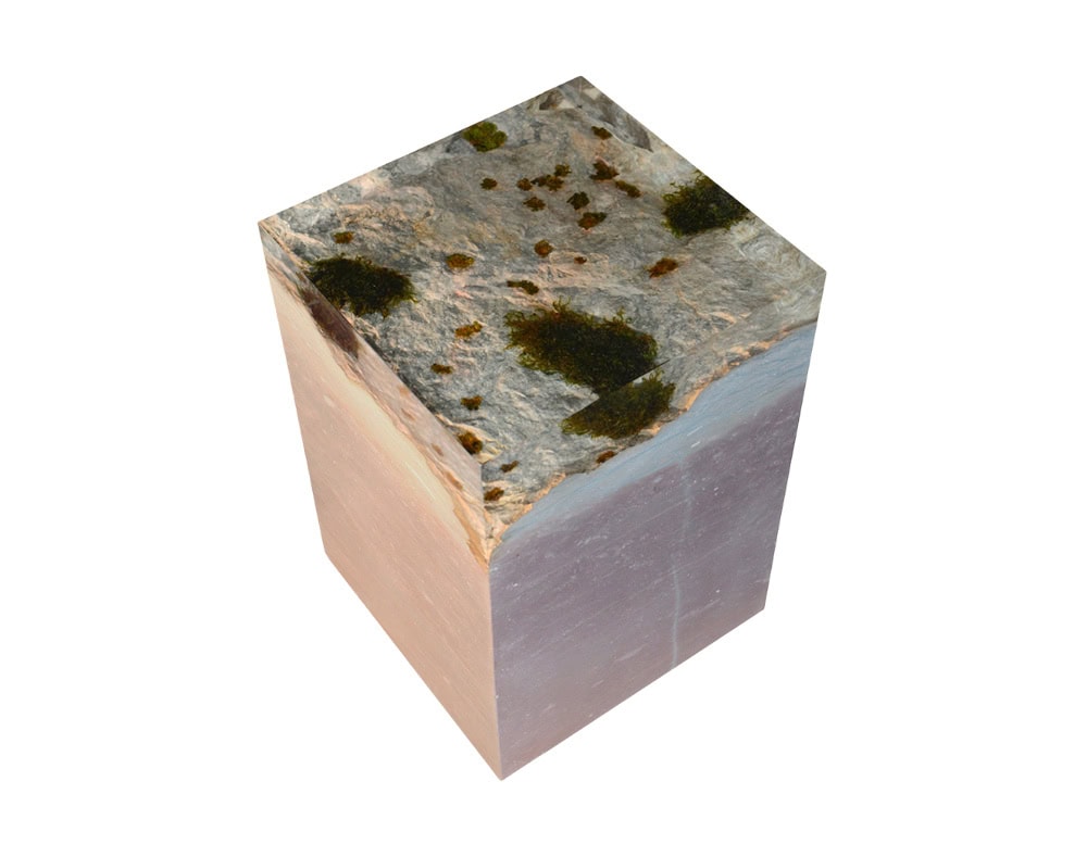 The Dolomyth Stool blends natural stone and moss within resin, evoking the rugged beauty of alpine landscapes while serving as a functional sculptural piece.