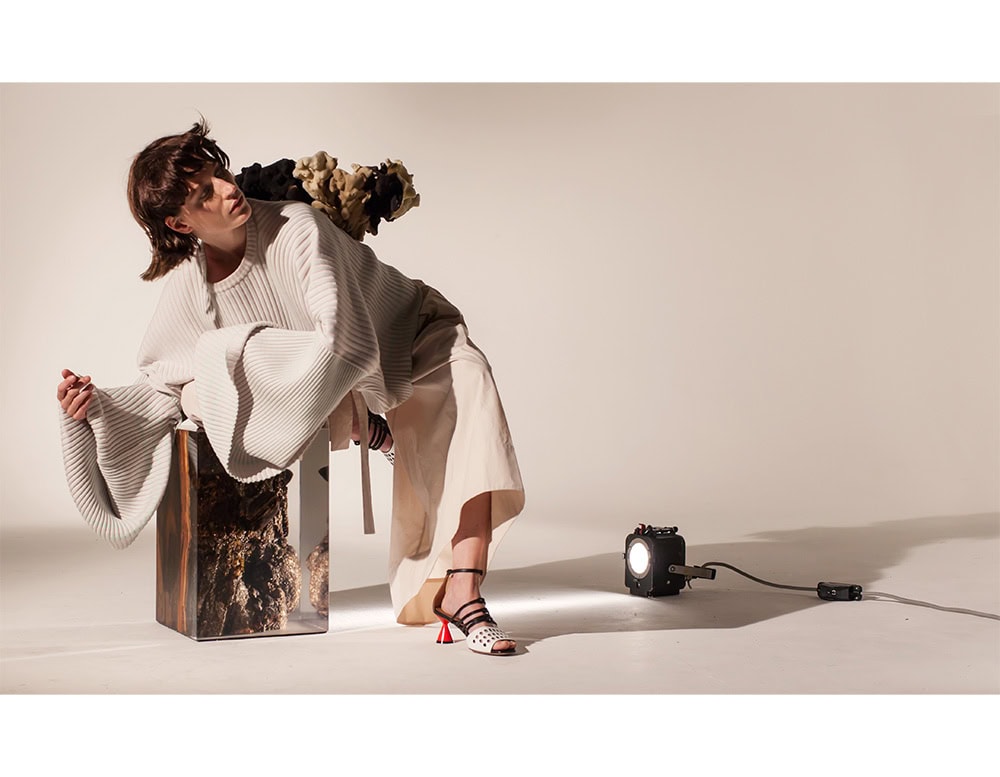 The Fungi Stool blends organic textures with sleek resin, encasing raw wood formations in a clear block. Functional as seating or a side table, it highlights the contrast between rugged natural detail and modern design.