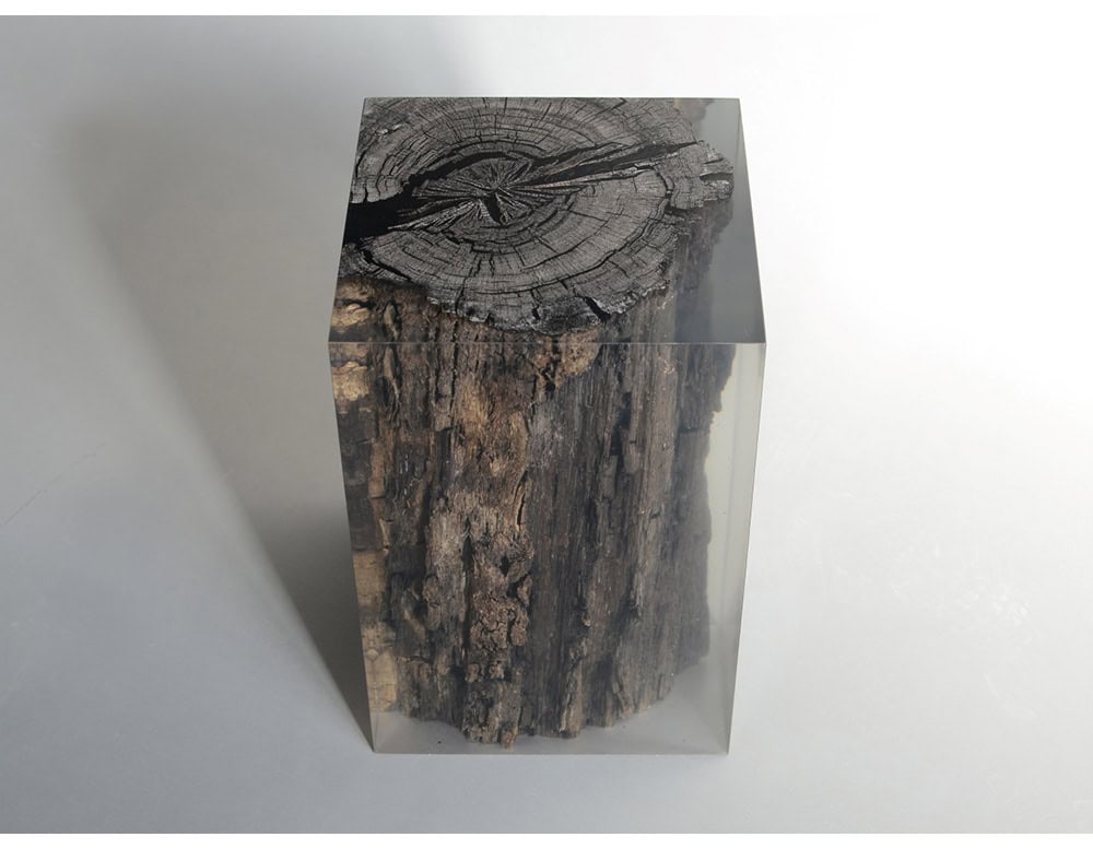 The Peatland Stool features ancient wood encased in clear resin that preserves its organic texture while creating a striking modern form. Each piece is unique, blending natural history with contemporary design.