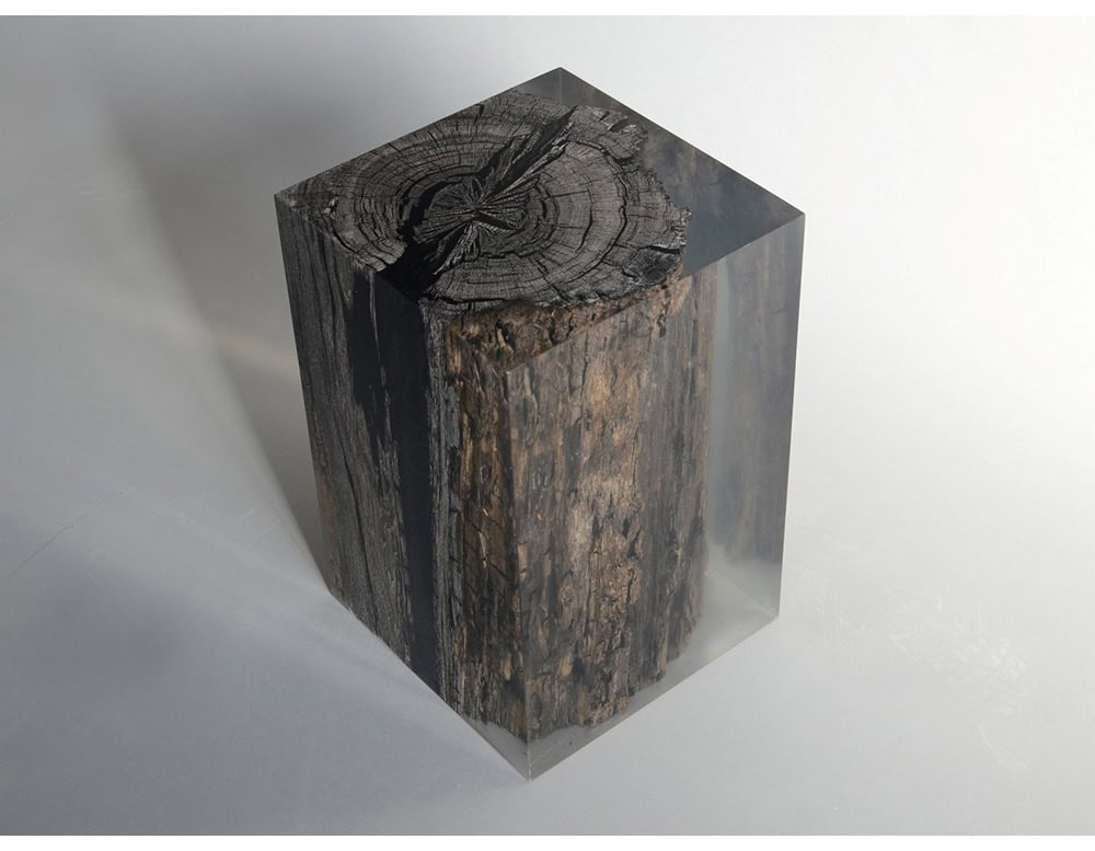 Handcrafted stool featuring preserved peatland wood encased in clear resin creating a striking blend of natural texture and modern design for versatile seating or display.
