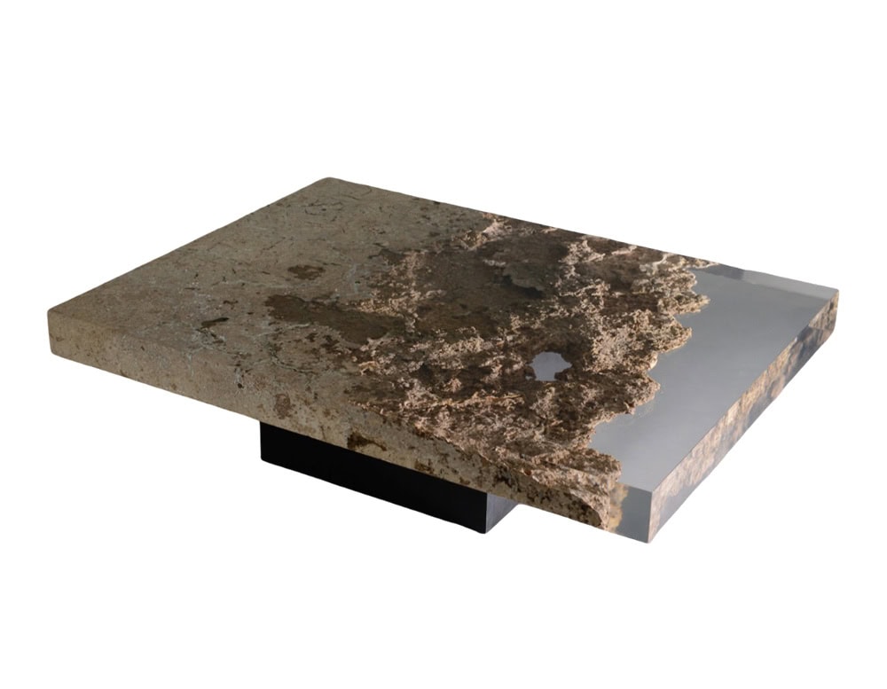 Rapolano Low Table reveals a textured stone like surface embedded in resin, creating depth and contrast. With its broad rectangular top and low profile base, it feels both sculptural and modern.