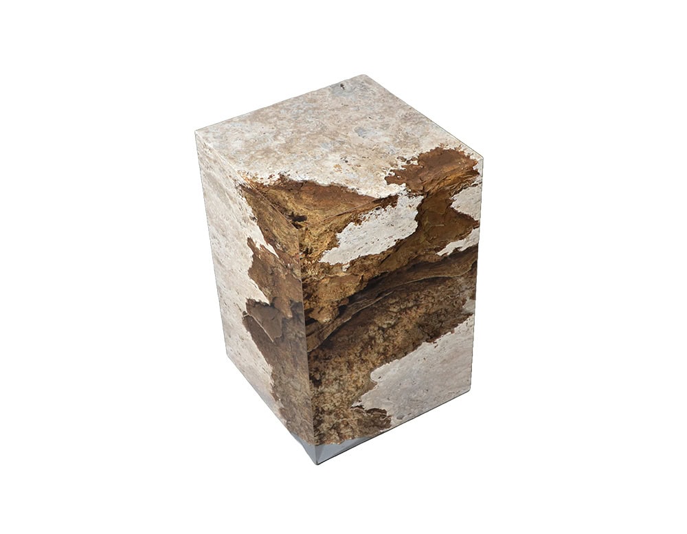 Rapolano Stool showcases rugged stone textures encased in resin, shaped into a clean cubic form. Its polished surface contrasts with organic detail, creating a modern sculptural seat.