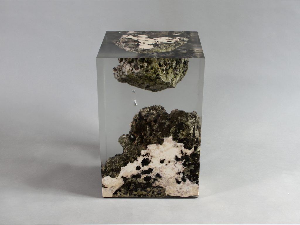 Floating Karst Stool/Side Table with a geometric design, made of natural stone with a transparent resin inlay, set against a gray background.