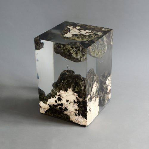 Floating Karst Stool/Side Table with a geometric design, made of natural stone with a transparent resin inlay, set against a gray background.