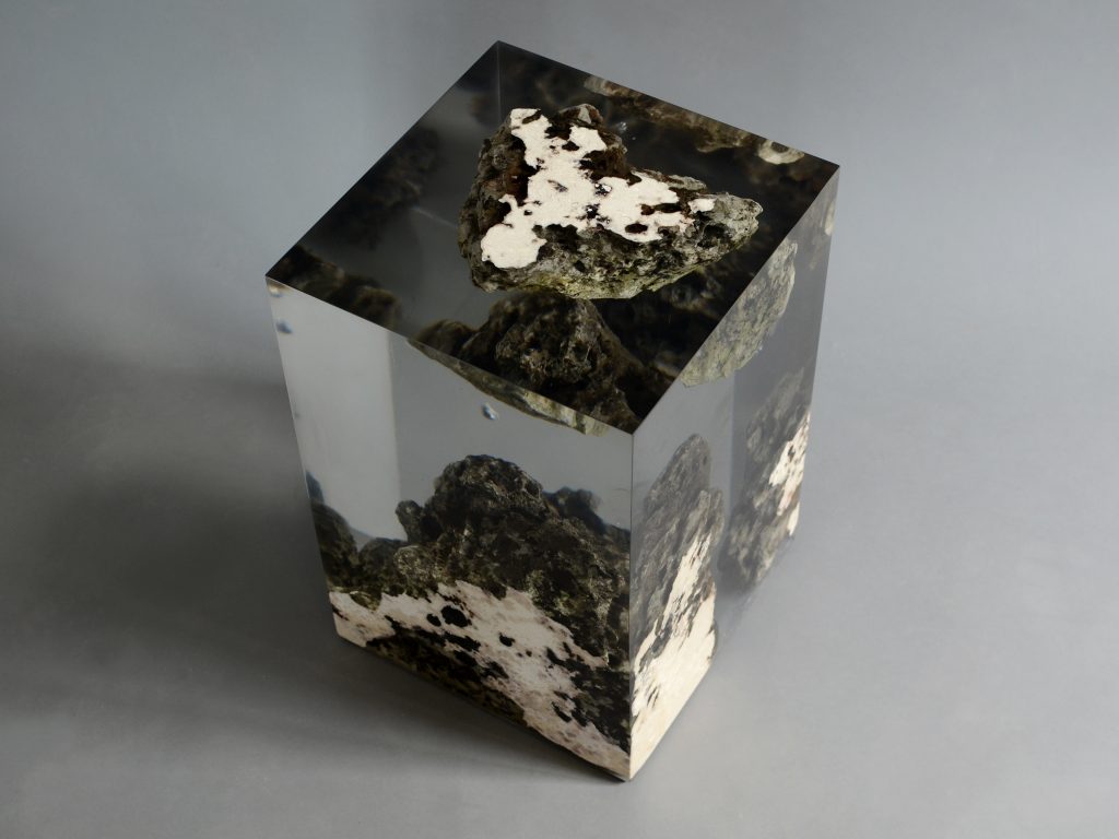 Floating Karst Stool/Side Table with a geometric design, made of natural stone with a transparent resin inlay, set against a gray background.