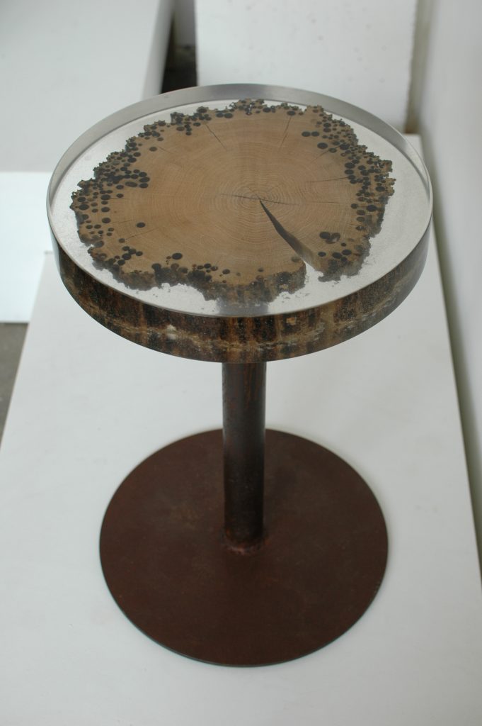 Mareale Stool with a round top and tapered legs, made of natural finish solid wood with a transparent resin inlay , set against a white background.
