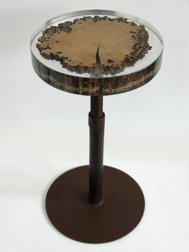 Mareale Stool with a round top and tapered legs, made of natural finish solid wood with a transparent resin inlay , set against a white background.