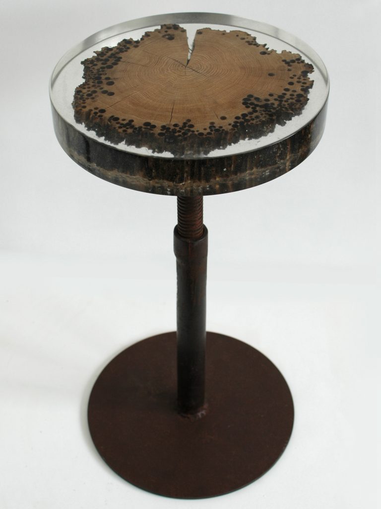 Mareale Stool with a round top and tapered legs, made of natural finish solid wood with a transparent resin inlay , set against a white background.