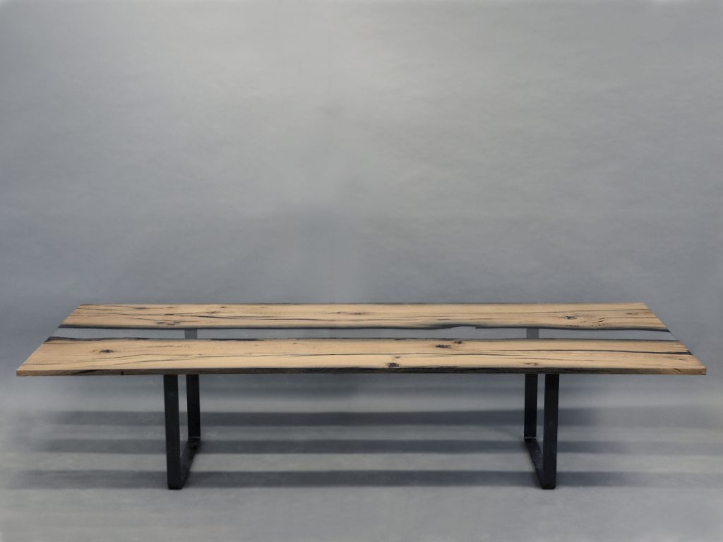 table made of wood and resin base in a light brown tone on a steel base