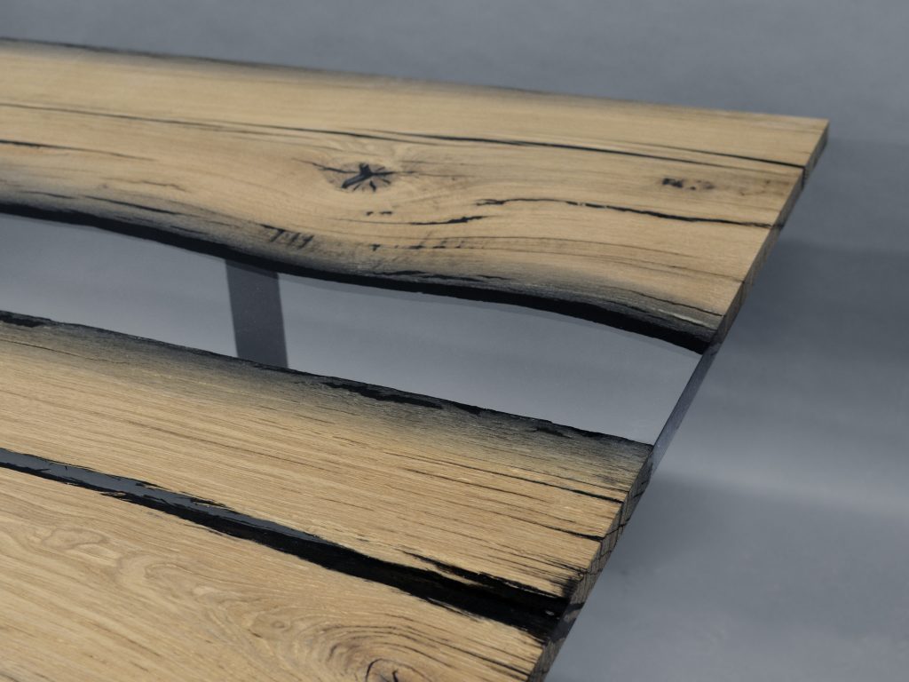 table made of wood and resin in the center of its structure in a light brown with black tone