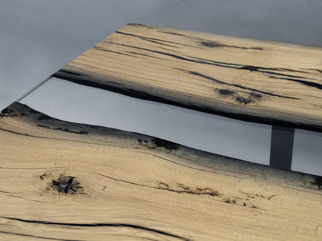 table made of wood and resin in the center of its structure in a light brown with black tone