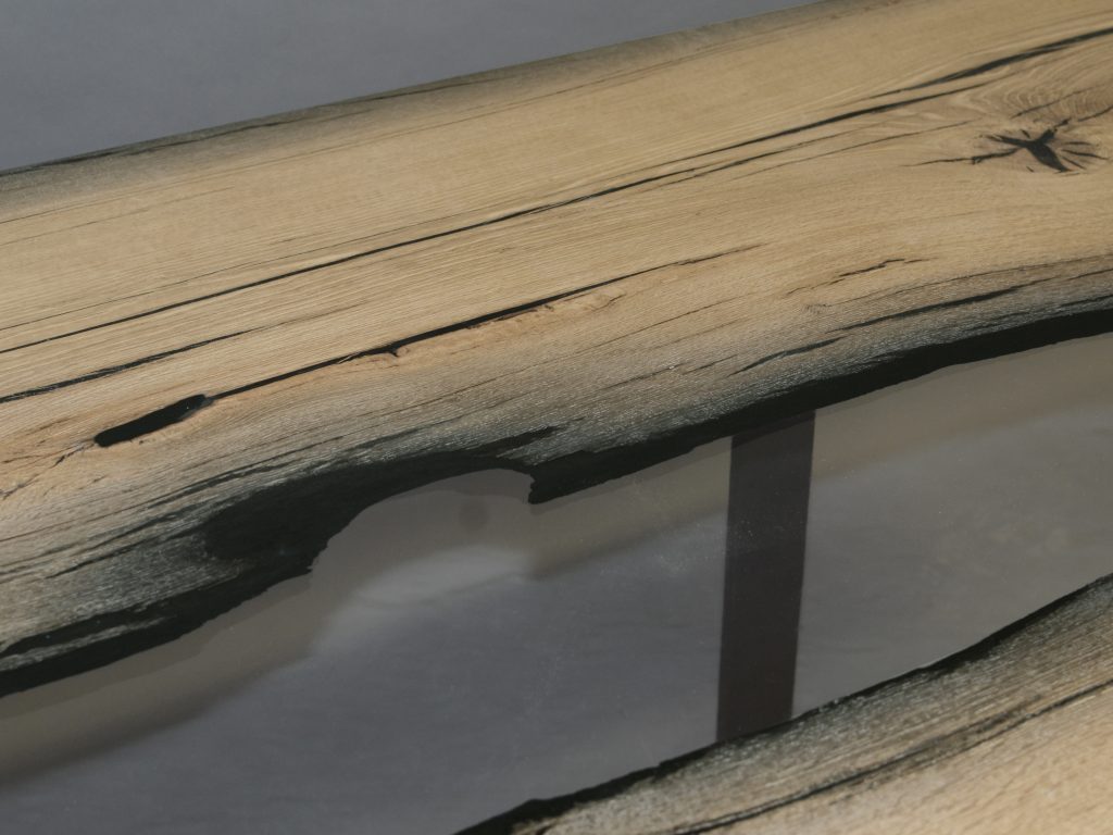 table made of wood and resin in the center of its structure in a light brown with black tone