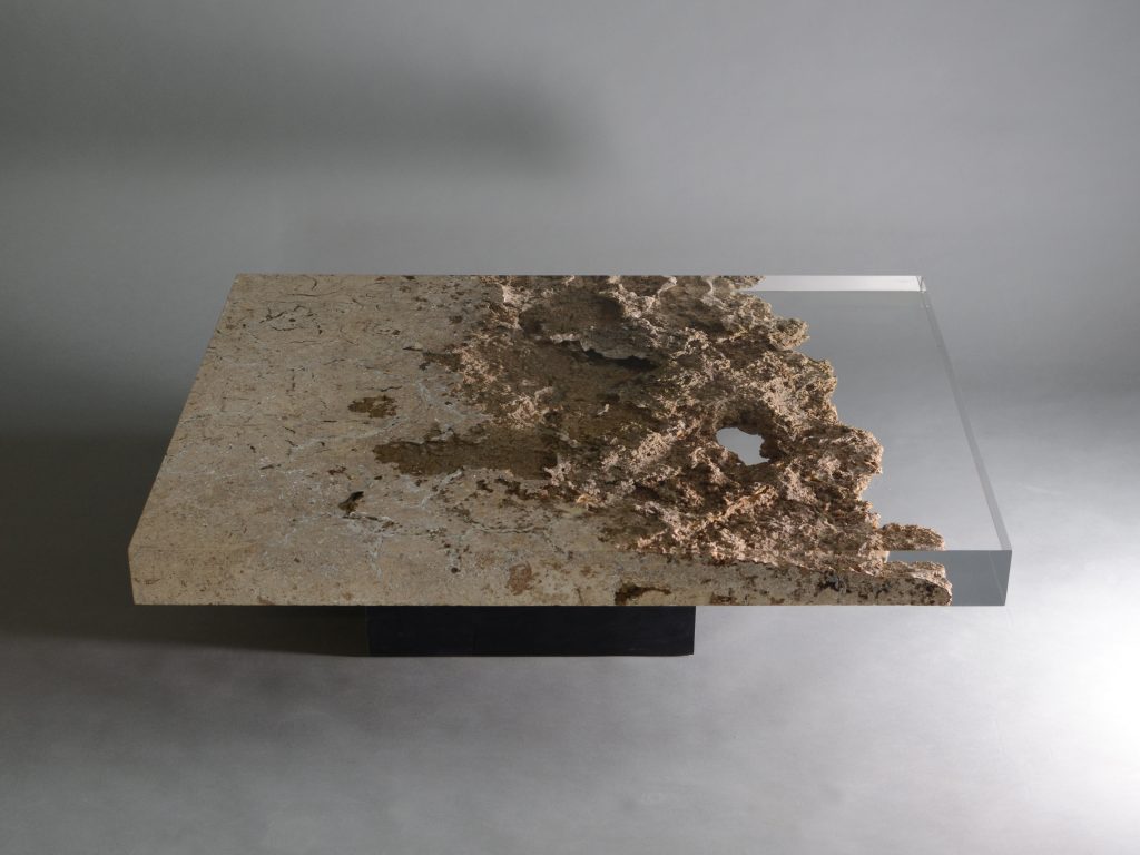 small plate made of natural stone and transparent glass in a brown tone on a gray background