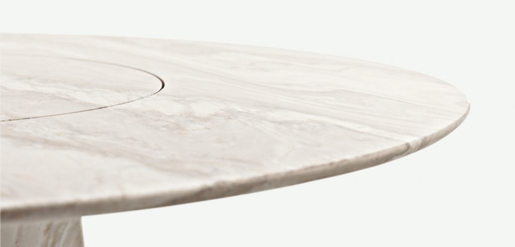 dining table made of natrual stone in a cream color tone on a white background