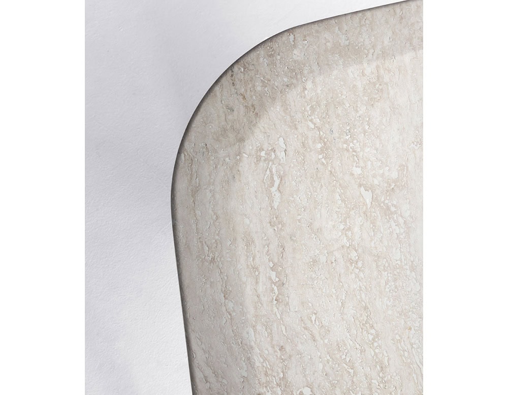 A close-up of a Giotto Outdoor Dining Table shows a white marble tabletop corner with a rounded edge against a white background
