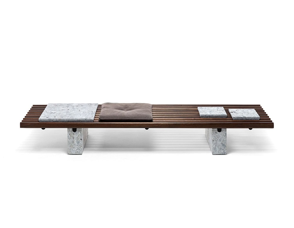 Panarea Coffee Table. Upper part made of brown wooden sticks and lower part is a block of gray stone on a white background.