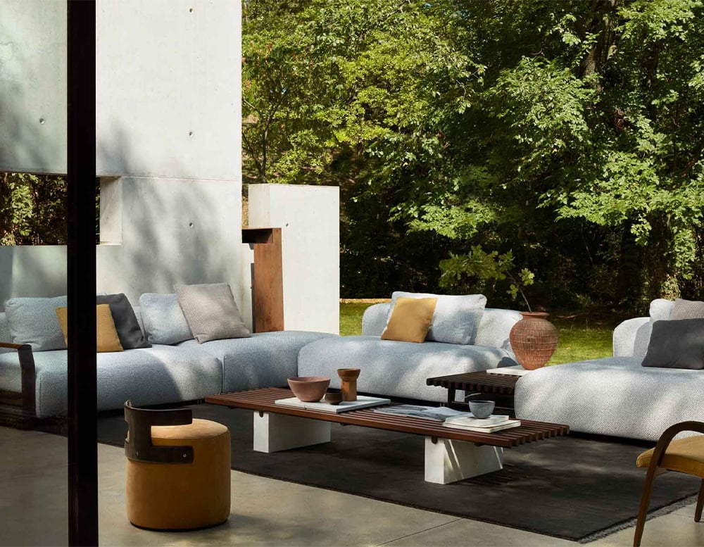 Four Panarea Sofas in gray fabric with backrest in a living room.